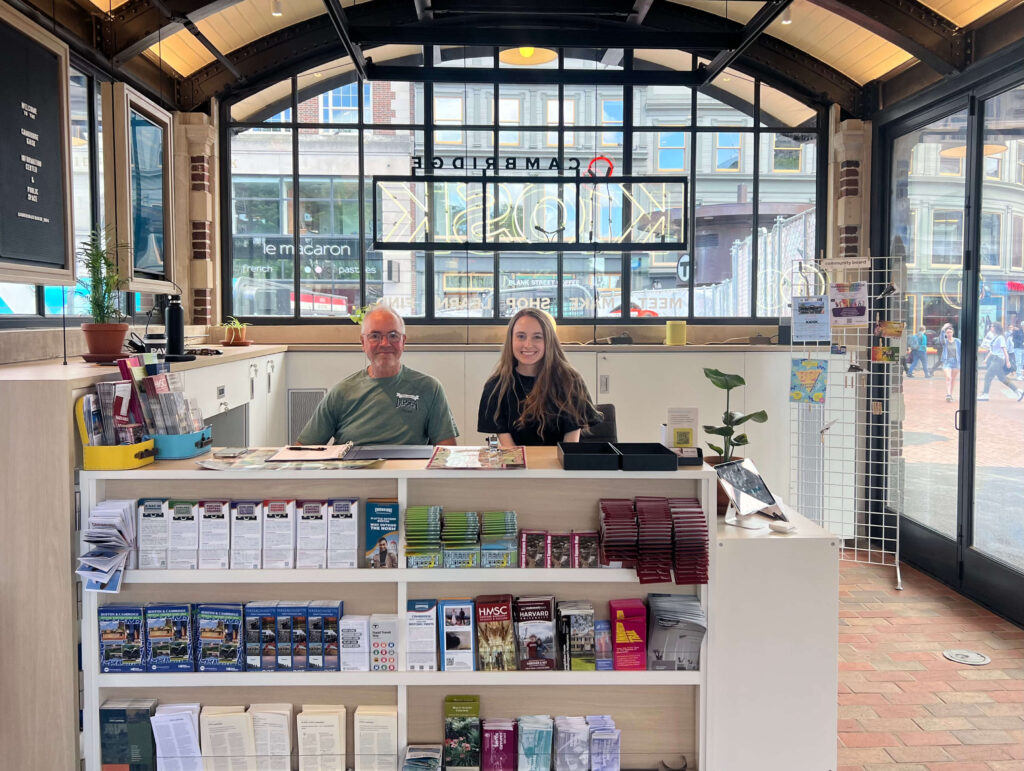 Exterior view of a traditional-style building with a sign that reads ‘Hotel Uday Palace’, surrounded by plants and motorcycles parked in front.